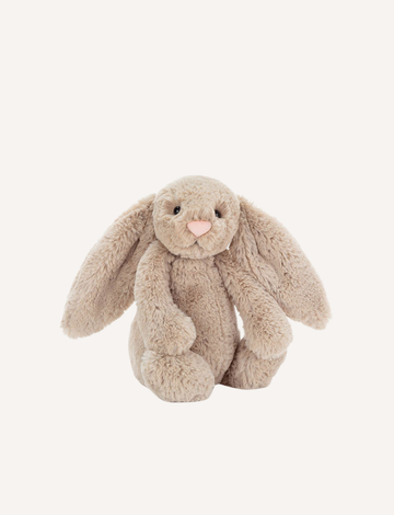 Introducing the Bashful Bunny by Jellycat, a charming plush toy shaped like a beige rabbit with long, floppy ears. This endearing bunny features a pink nose and inner ears, along with a content expression on its face. Made with Jellycat's signature soft fur, Bashful Bunny is posed sitting upright against a plain white background—making it the perfect gift!