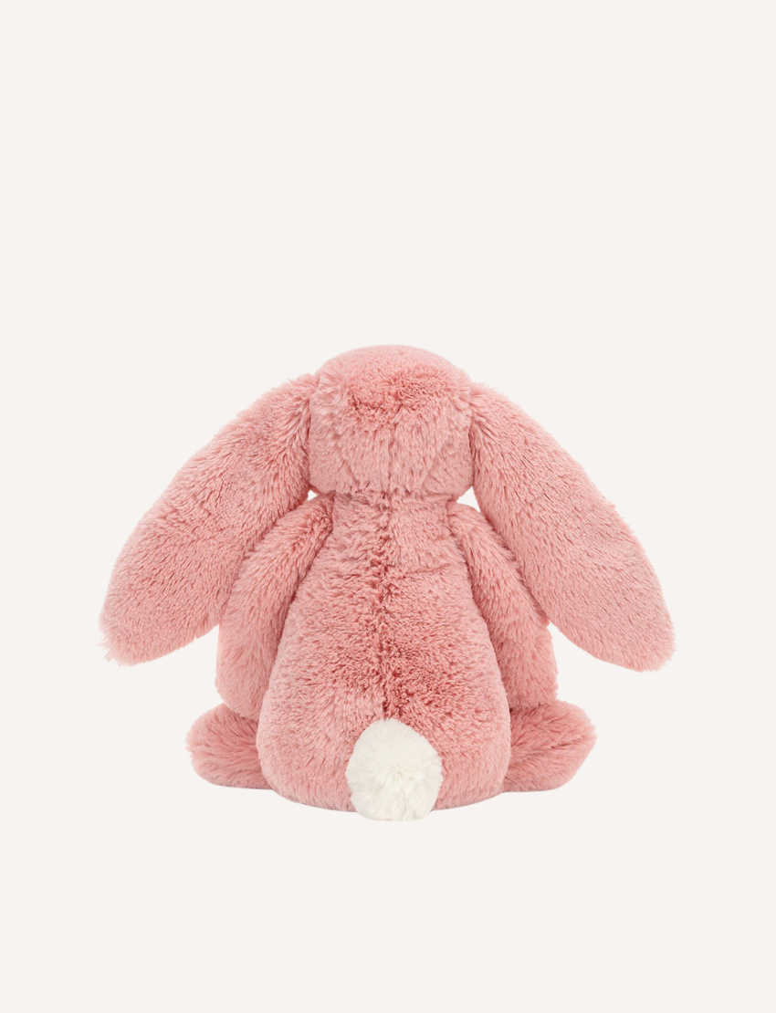 Introducing the Bashful Bunny by Jellycat, a charming plush toy shaped like a beige rabbit with long, floppy ears. This endearing bunny features a pink nose and inner ears, along with a content expression on its face. Made with Jellycat's signature soft fur, Bashful Bunny is posed sitting upright against a plain white background—making it the perfect gift!