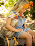 Rupert the Rooster, a plush toy from Nana Hutchy, sits against a plain background. The toy features brown and white striped fur, an orange beak and comb, and long yellow legs with three toes each extending outward.