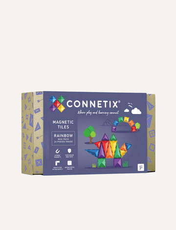 The Connetix Tiles Rainbow Mini Pack 24-Piece set is on display. The packaging features a purple and beige design with illustrations of vibrant magnetic tiles creating a rocket and various shapes. It includes 24 pieces and is suitable for children aged 3 and older.