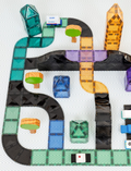 A yellow box of Connetix Ramps & Intersections Pack 16-Piece by Connetix Tiles. The packaging showcases illustrations of road tiles and cityscape elements, complete with trees and cloud graphics. Suitable for ages 3 and up.