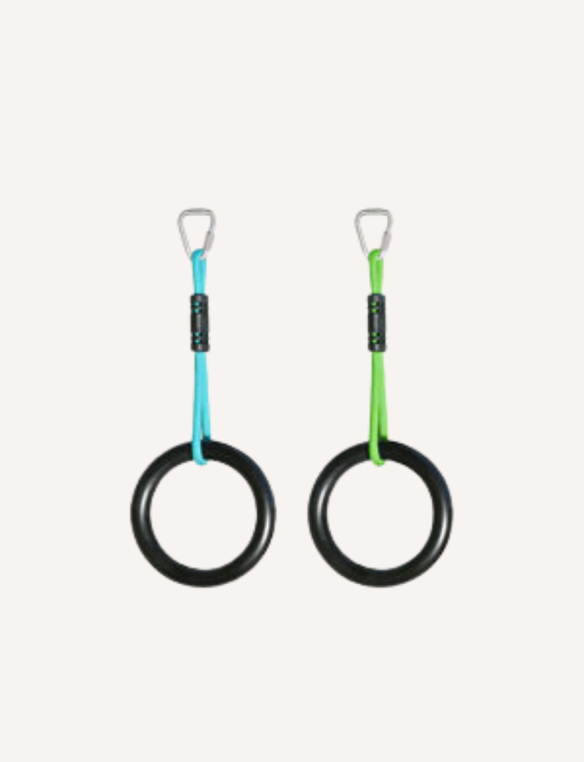 The image depicts the packaging for Slackers' Ninja Rings - set of 2. The box showcases a child hanging from two black rings connected to vibrant straps. It is marked as suitable for ages 5 and up and includes the set of two ninja rings.