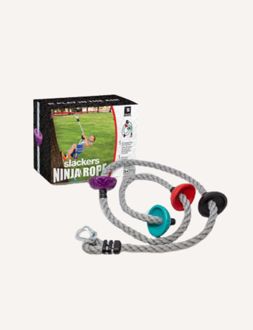 The Slackers Ninja Climbing Rope 8' with Foot Holds includes a durable rope equipped with three vibrant plastic grips and a metal carabiner. The packaging displays an image of an individual utilizing the rope for outdoor exercise.