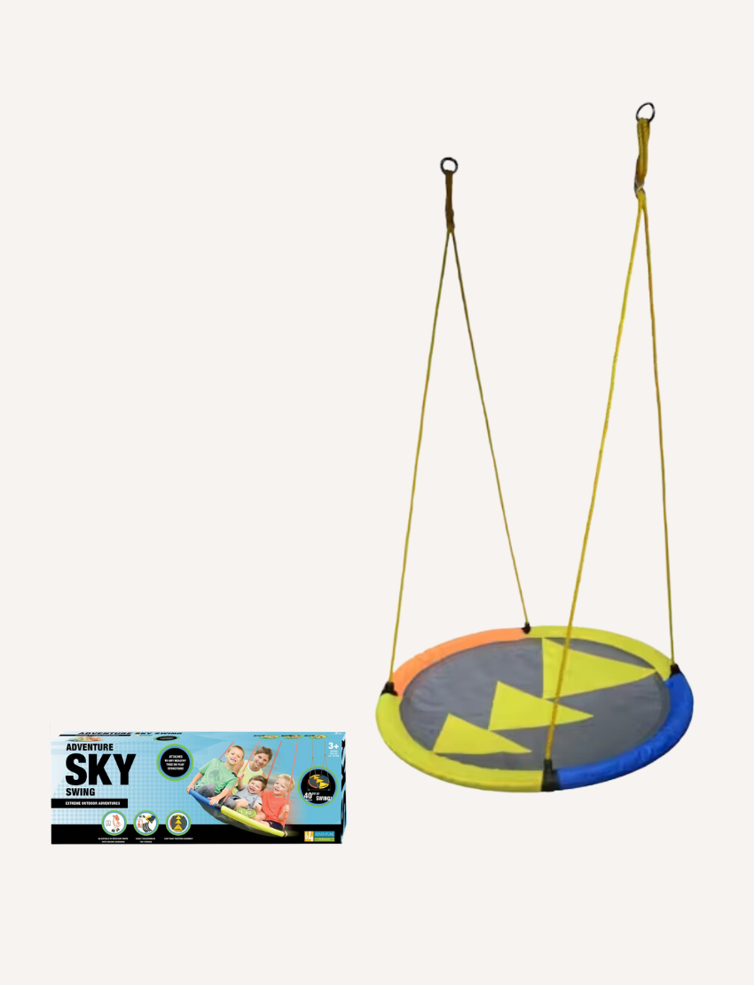 A circular platform swing with yellow, blue, and orange sections hangs by ropes. The product box shows kids using the b4Adventure Sky Adventure Swing Chair with the text "Adventure Sky Swing," inviting imaginative adventures for all ages.