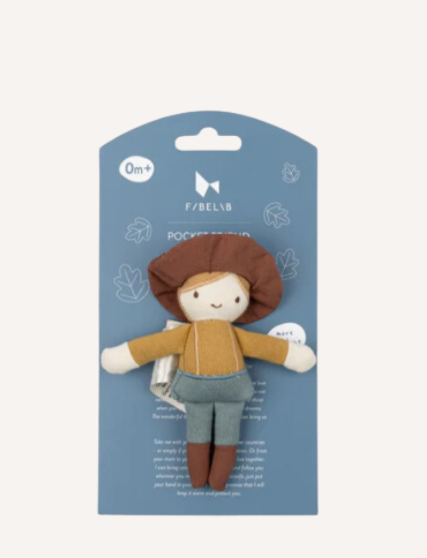 Introducing Pocket Friend - Farmer Joe by Fabelab: a charming fabric doll donning a brown hat, yellow shirt, blue overalls, and brown shoes. This delightful character features simple facial details with two eyes and a smiling mouth. Photographed against a plain white background.