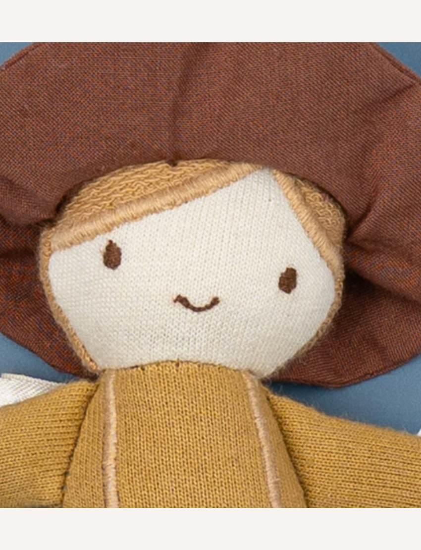 Introducing Pocket Friend - Farmer Joe by Fabelab: a charming fabric doll donning a brown hat, yellow shirt, blue overalls, and brown shoes. This delightful character features simple facial details with two eyes and a smiling mouth. Photographed against a plain white background.