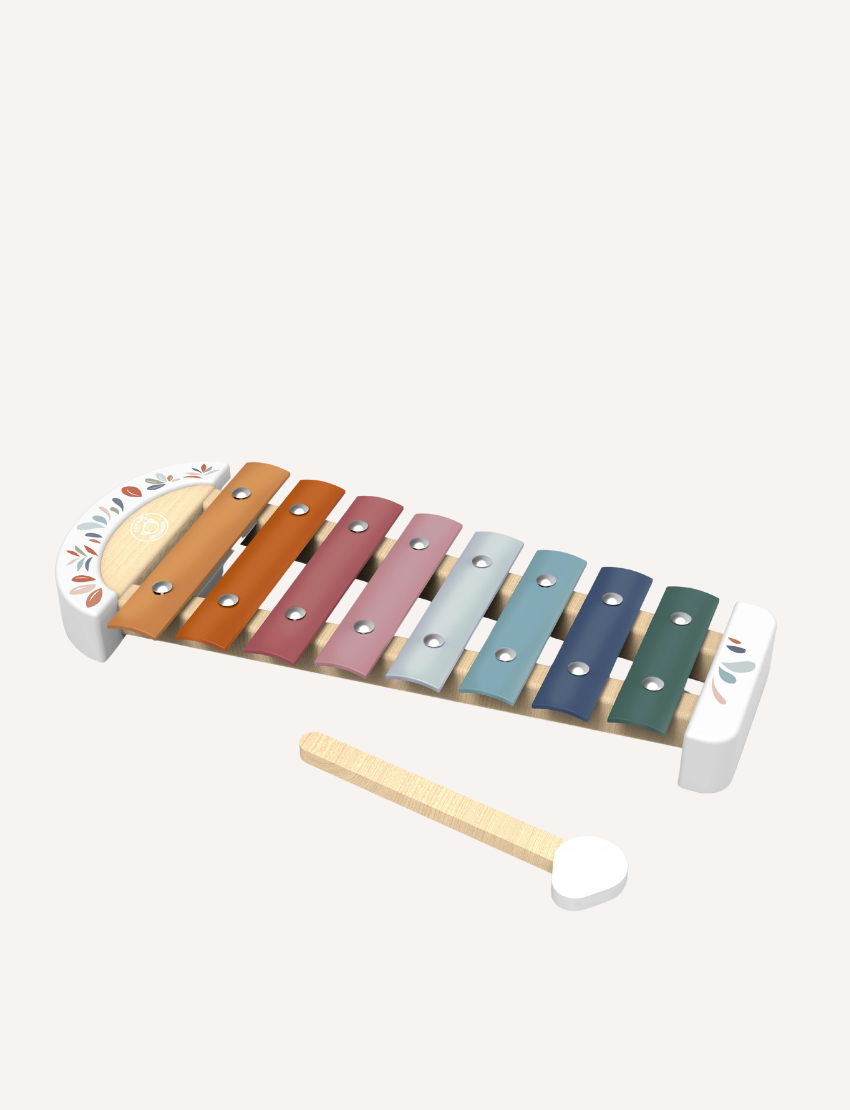 The Speedy Monkey Xylophone, featuring eight vibrant metal bars in shades of orange, yellow, green, blue, and pink, rests on a white surface. In front of the instrument lies a wooden mallet with a rounded white end.