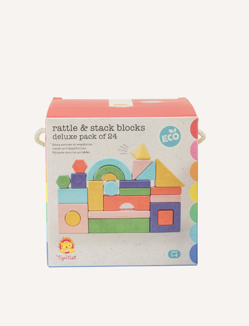 The "Rattle & Stack Blocks - Deluxe Pack of 24" from Tiger Tribe includes a vibrant collection of blocks in different shapes and sizes. The packaging is eco-friendly, designed for children aged 1-4, and features a convenient handle for easy transportation.