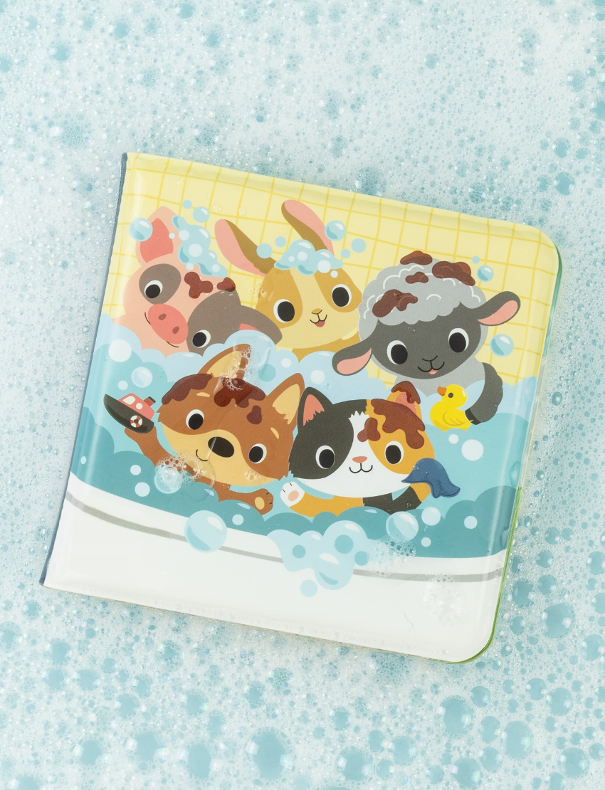 The "Bath Book - Messy Farm" from Tiger Tribe is a colorful children's bath book packaged in a vibrant, circular box. The cover features illustrated farm animals peeking out of a bubble bath and is suitable for ages 6 months to 3 years.