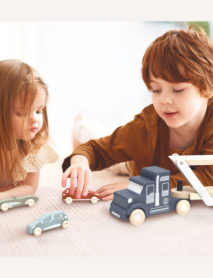 The Speedy Monkey Car Transporter is a wooden vehicle set that includes a blue toy truck with a double-deck trailer. It carries four vibrant wooden cars painted in red, green, orange, and maroon using non-toxic paint. The detachable trailer also features a white support frame for enhanced stability.