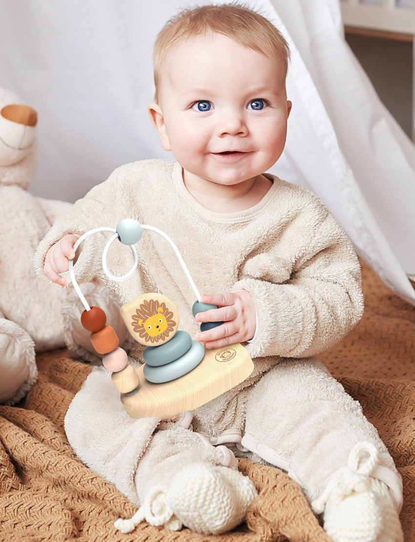 The Speedy Monkey Bead Maze showcases an enchanting lion illustration and is made from sustainably sourced wood. It features vibrant beads on two wire tracks, stackable circular elements, and a lightweight wooden base designed to foster hand-eye coordination in young children.