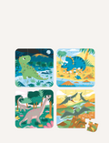 Four vibrant jigsaw puzzles from Janod's Progressive Puzzles Dinosaurs collection are displayed, each featuring distinct dinosaur scenes: a green dinosaur set against a nighttime backdrop, a blue one roaming the desert, a gray one amidst trees, and flying dinosaurs soaring over a volcano. One of these puzzles has several missing pieces.