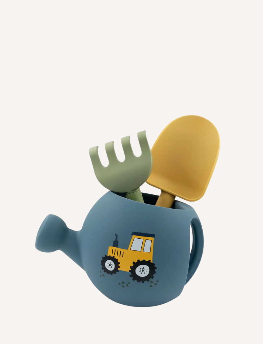 Blue watering can with a tractor design, holding a green rake and yellow spade.