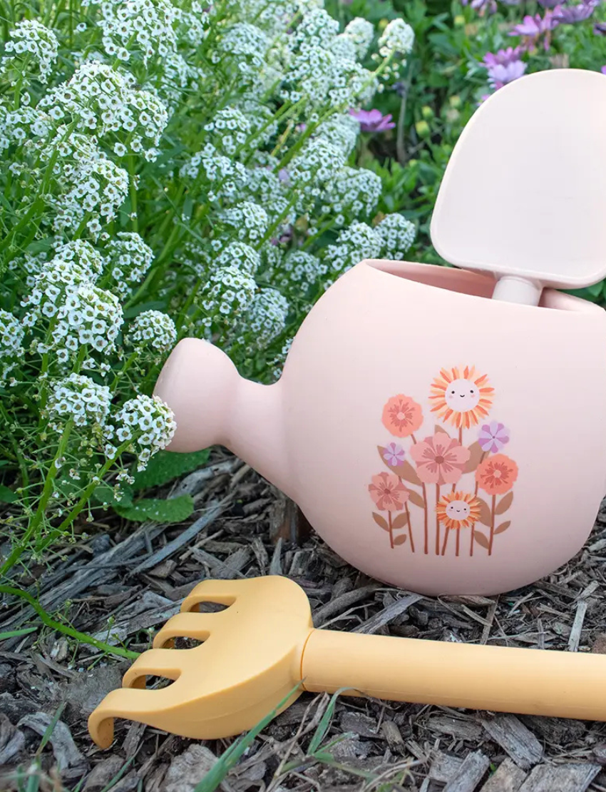 The Playground "My First Gardening Set" includes a blue silicone watering can with a yellow tractor, a green recycled rake, and a yellow spade for an ideal gardening experience.