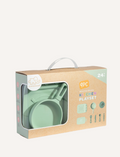 The Silicone Kitchen Playset by Playground features a selection of pastel green toy kitchen utensils, including a saucepan, a pot with a lid, a spatula, and a ladle—all arranged on a matching silicone mat. The items are showcased neatly against a simple backdrop.