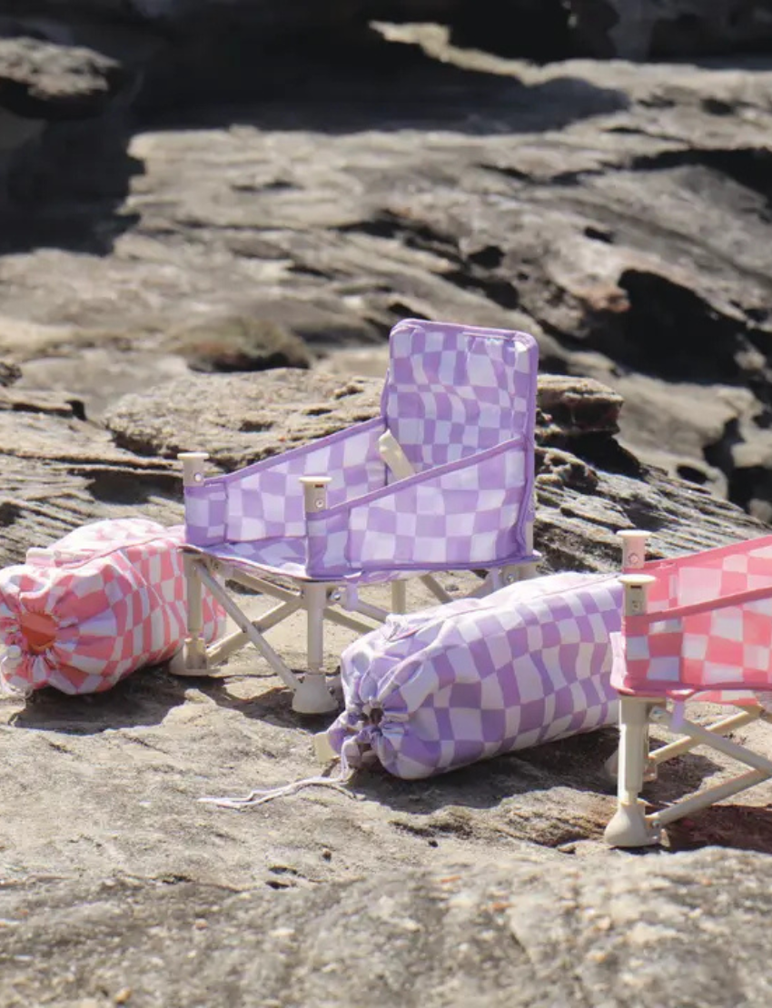 The IZIMINI Baby Chair features a lightweight, portable design with a foldable metal base and floral fabric in orange, blue, and purple, plus a beige plastic tray.