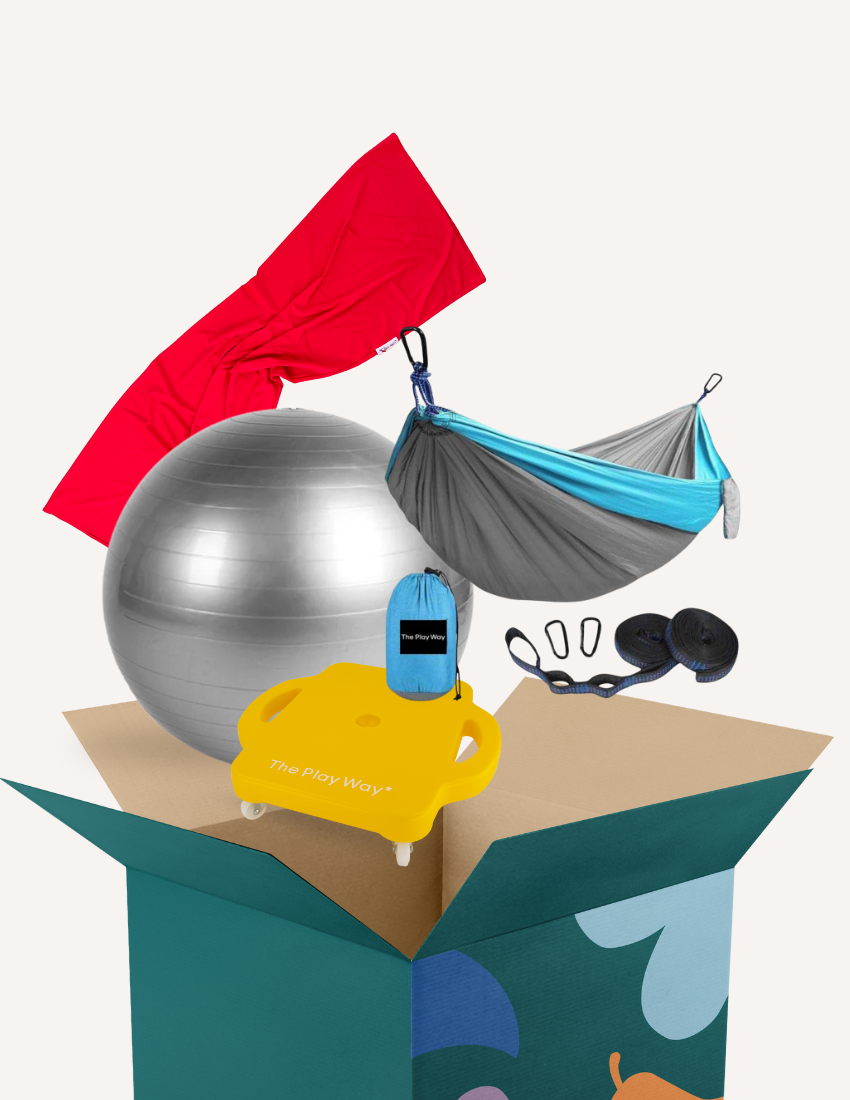 The Play Way's Regulation Through Movement Kit is opened, showcasing a hammock swing with a blue edge, a gray exercise ball, and a yellow scooter board with four casters. Various accessories for sensory regulation can be seen partly inside and around the green and blue box.