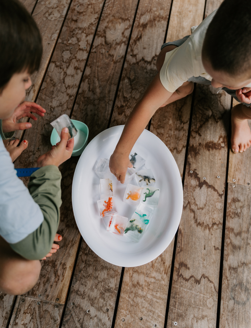 A person holds a Sensory Play Australia card from the "Sensory Play Cards Set in Box" featuring a recipe for "Cloud Dough" and an image of hands holding colorful dough balls. The table also has a whisk, spatula, mixing bowl, measuring cups, and another card from the same set in the background.