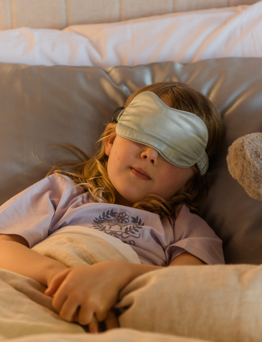 A round, light blue box labeled "Sensory Play Australia" contains the "Sleep Set," which includes a white cylindrical bottle labeled "Melo Dream," a brown spray bottle labeled "Melo," and a folded light blue fabric item, possibly an eye mask or pillowcase.