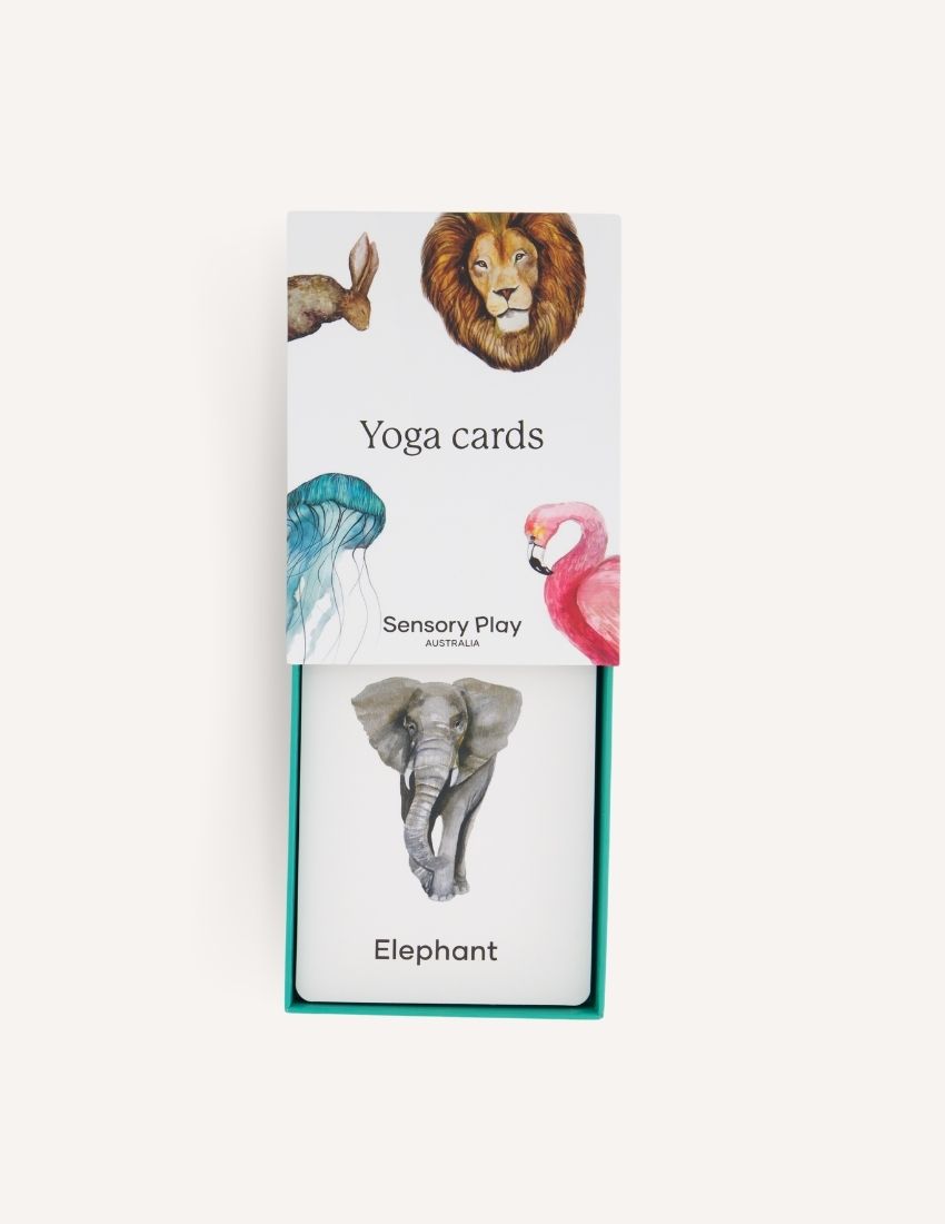 Introducing the "Yoga Cards Set in Box (SPA)" from Sensory Play Australia. The cover features delightful illustrations of a lion, kangaroo, jellyfish, and flamingo. Perfect for introducing mindfulness to kids, this set provides instructions, benefits, and colorful icons on the back of each card.