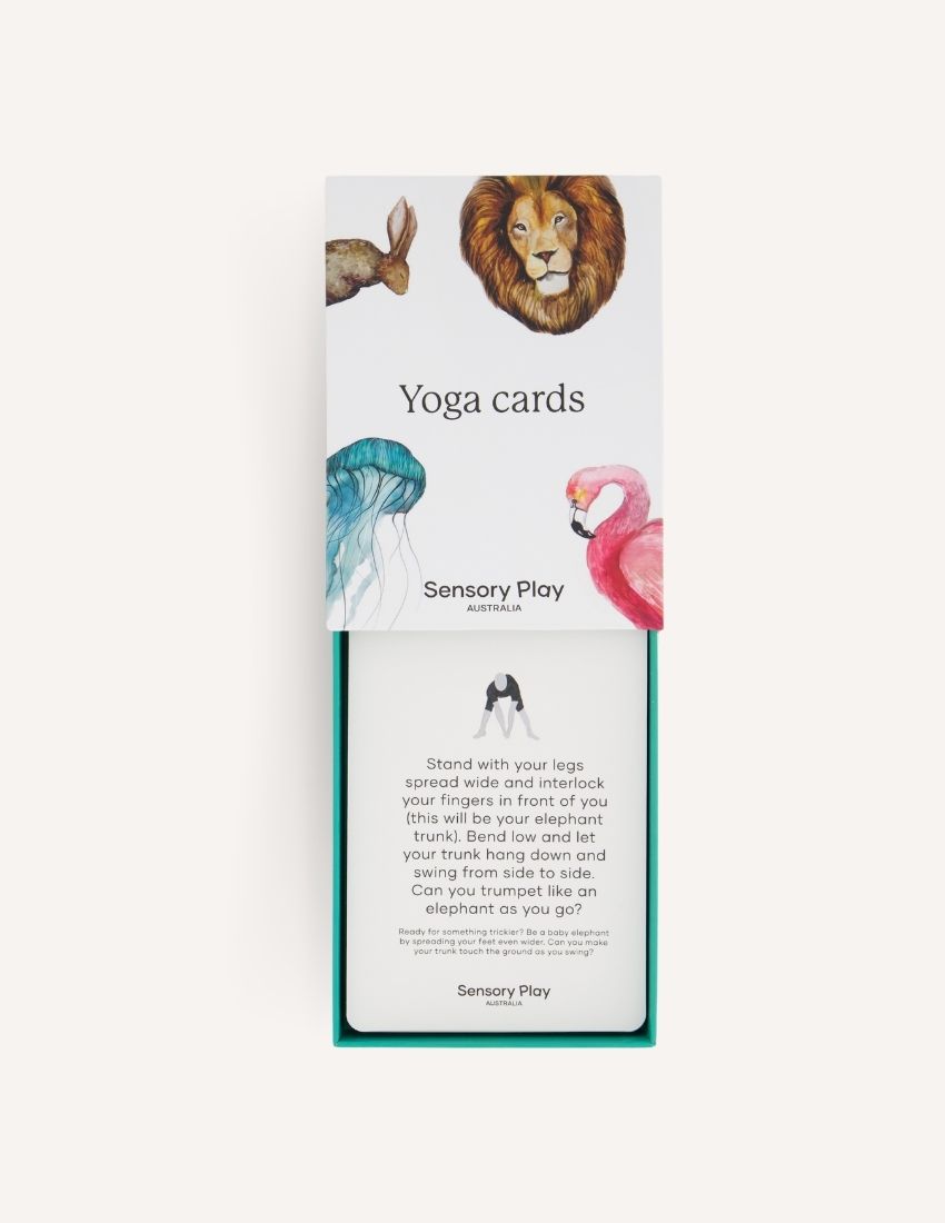 Introducing the "Yoga Cards Set in Box (SPA)" from Sensory Play Australia. The cover features delightful illustrations of a lion, kangaroo, jellyfish, and flamingo. Perfect for introducing mindfulness to kids, this set provides instructions, benefits, and colorful icons on the back of each card.