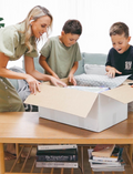 The Therapy At Home Handwriting in Practice Program includes a green and blue box with notebooks, pens, sticky notes, stickers, a pencil sharpener, planner sheets, a black carrying case, and a handwriting workbook for effective practice.