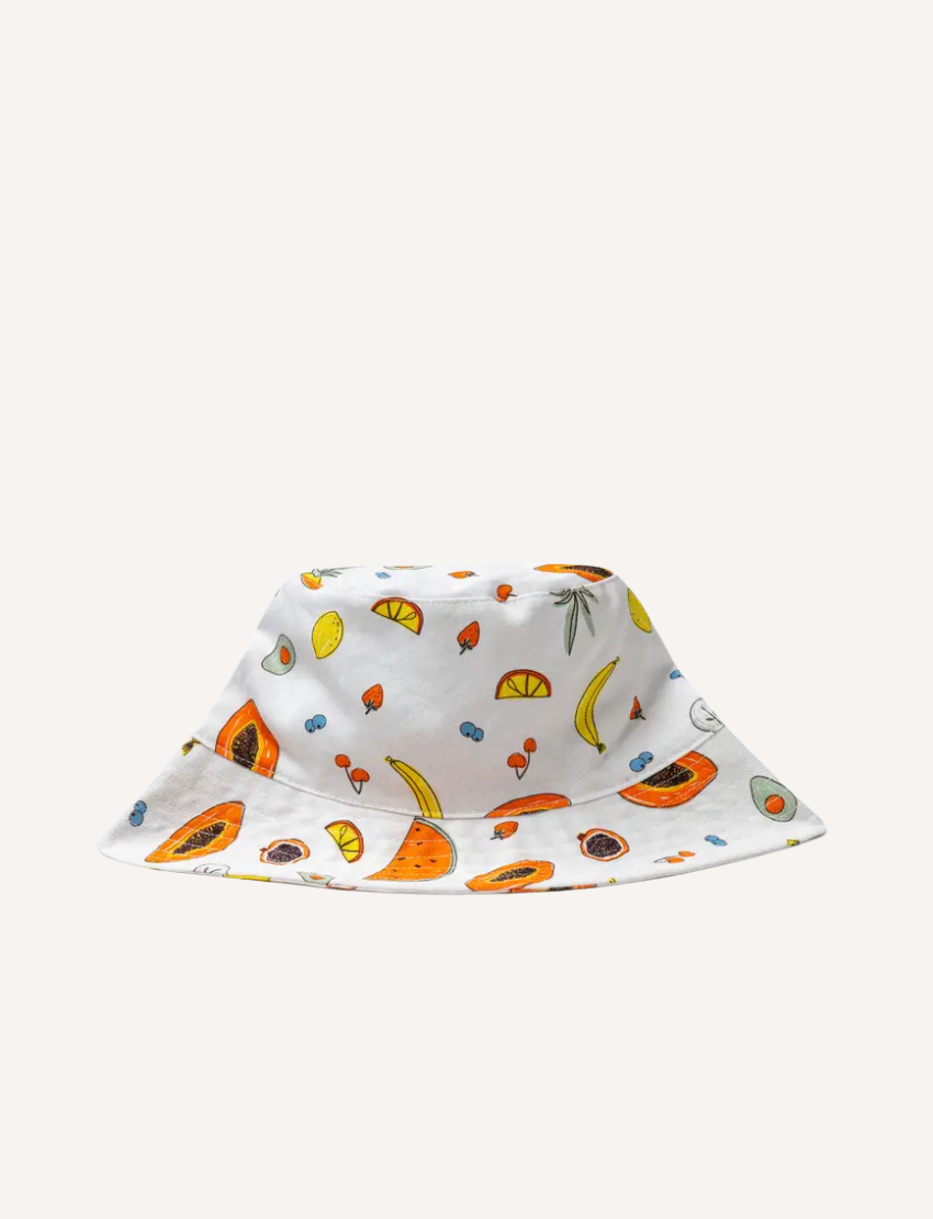 White bucket hat adorned with a playful pattern of fruits like papaya and bananas.
