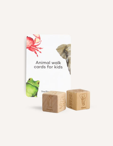 The "Animal Walk Card and Dice set" from Sensory Play Australia includes cards featuring illustrations of a frog, a crab, and an elephant, as well as two wooden dice. Each face of the dice displays engravings of different animals, such as a penguin and an elephant, encouraging imaginative physical activity for kids.