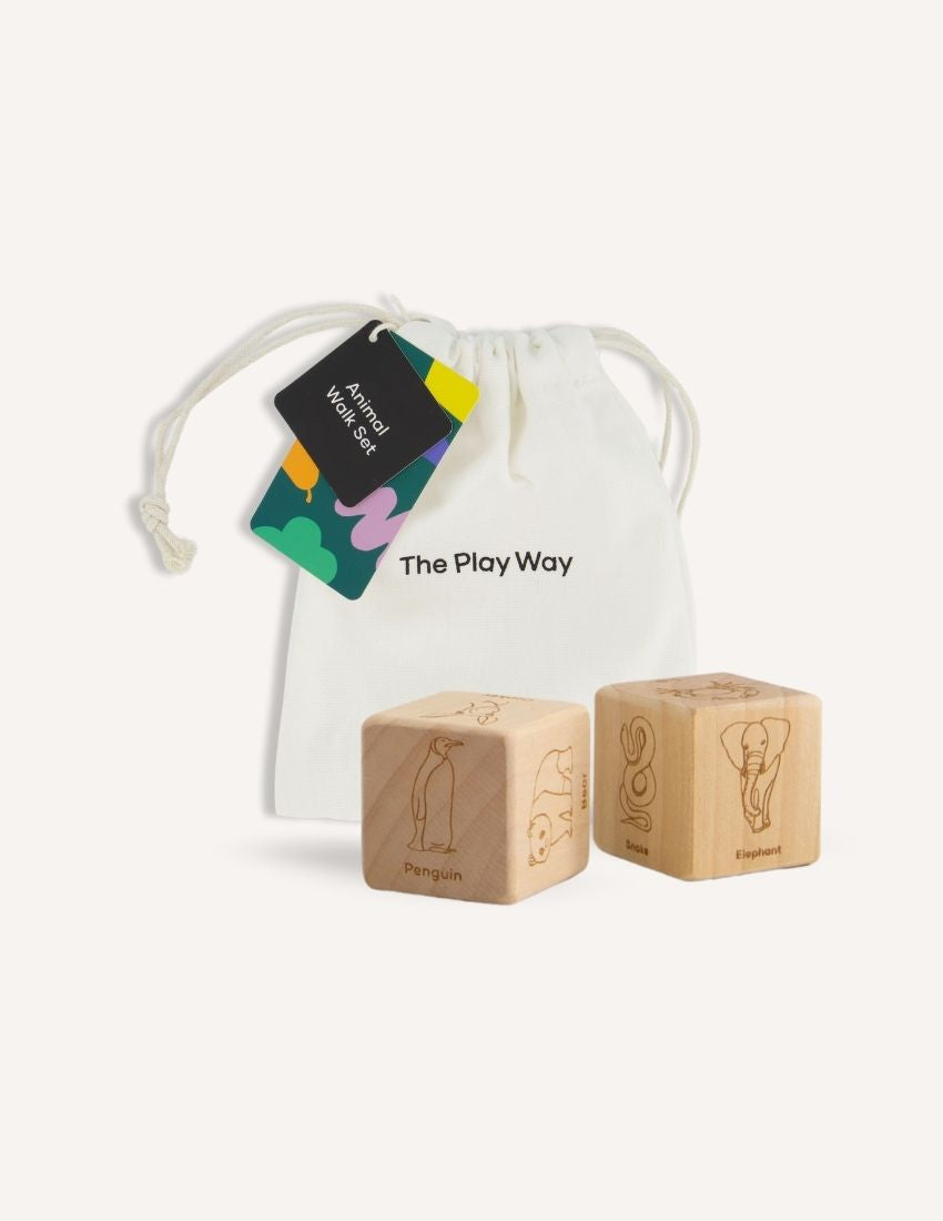 The "Animal Walk Card and Dice set" from Sensory Play Australia includes cards featuring illustrations of a frog, a crab, and an elephant, as well as two wooden dice. Each face of the dice displays engravings of different animals, such as a penguin and an elephant, encouraging imaginative physical activity for kids.