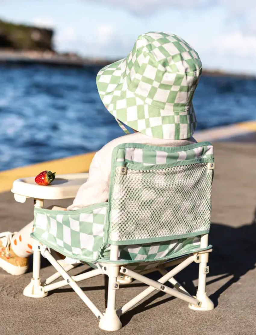 The IZIMINI Cotton Baby Hat is a vibrant bucket hat with a floral print of pink, orange, blue, and green leaves on white. Perfect for outdoor adventures with its wide brim and rounded top, it offers stylish sun protection.