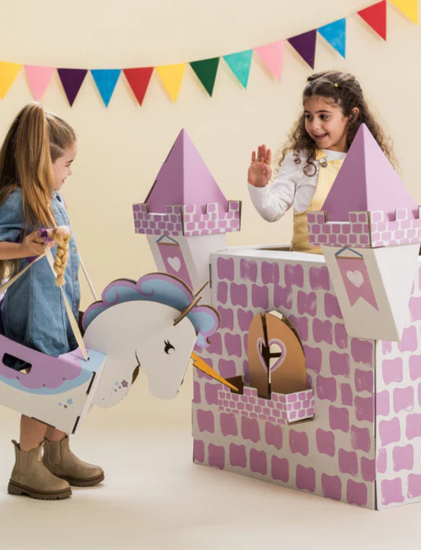 Introducing the Princess Castle by Les Petite Artistes: a charming cardboard play structure featuring four pointed turrets and a small heart-shaped window. This light gray castle is complete with an elegant arched window, perfect for imaginative play.