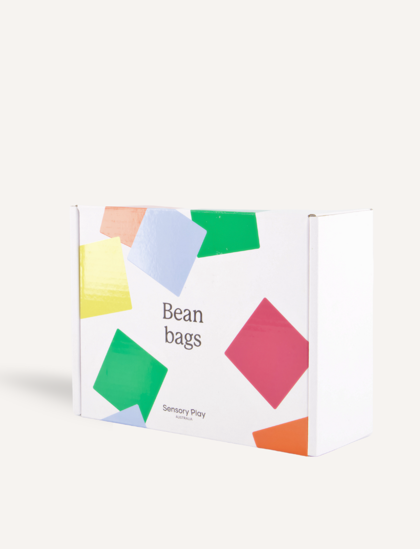 A white box with colorful geometric shapes has "Bean Bags" and "Sensory Play Australia" on the front. Ideal for motor skills and sensory regulation, it offers more than just fun—it's a developmental journey.