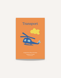 A large teal and orange cardboard box from The Play Way's Transport Kit is open, revealing paper models of vintage vehicles inside. The kit includes models of a carriage, an automobile, and a small cart. A card featuring the word 