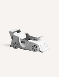 A large teal and orange cardboard box from The Play Way's Transport Kit is open, revealing paper models of vintage vehicles inside. The kit includes models of a carriage, an automobile, and a small cart. A card featuring the word 