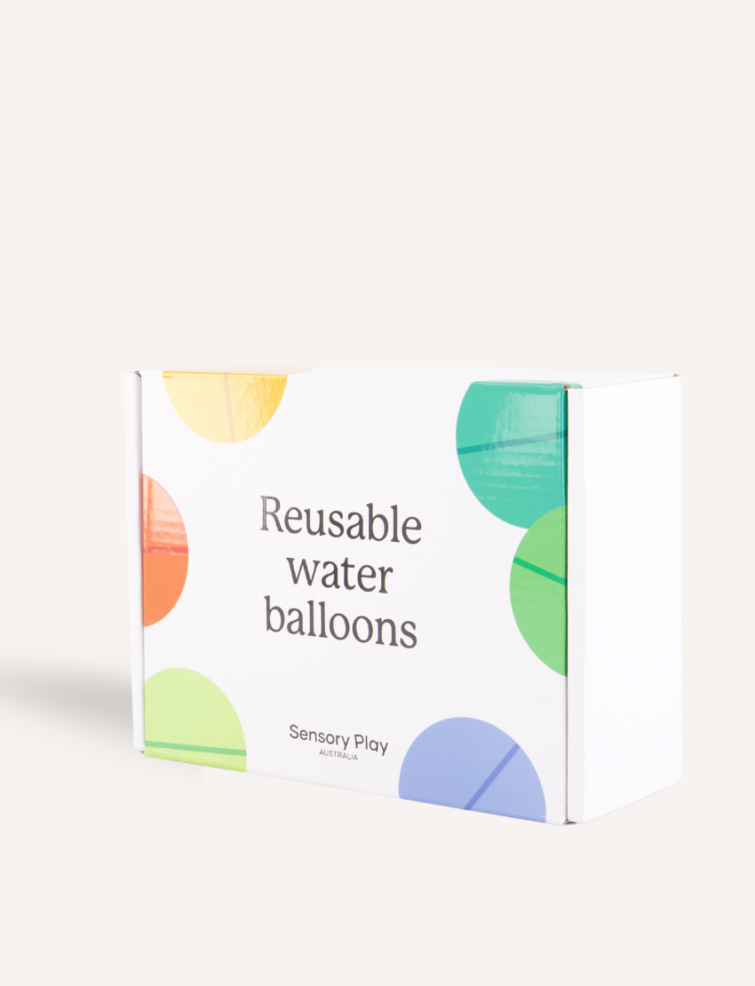 A white rectangular box with colorful circles features the text "Reusable Water Balloons" prominently. The eco-friendly package by Sensory Play Australia is set against a simple, light background.