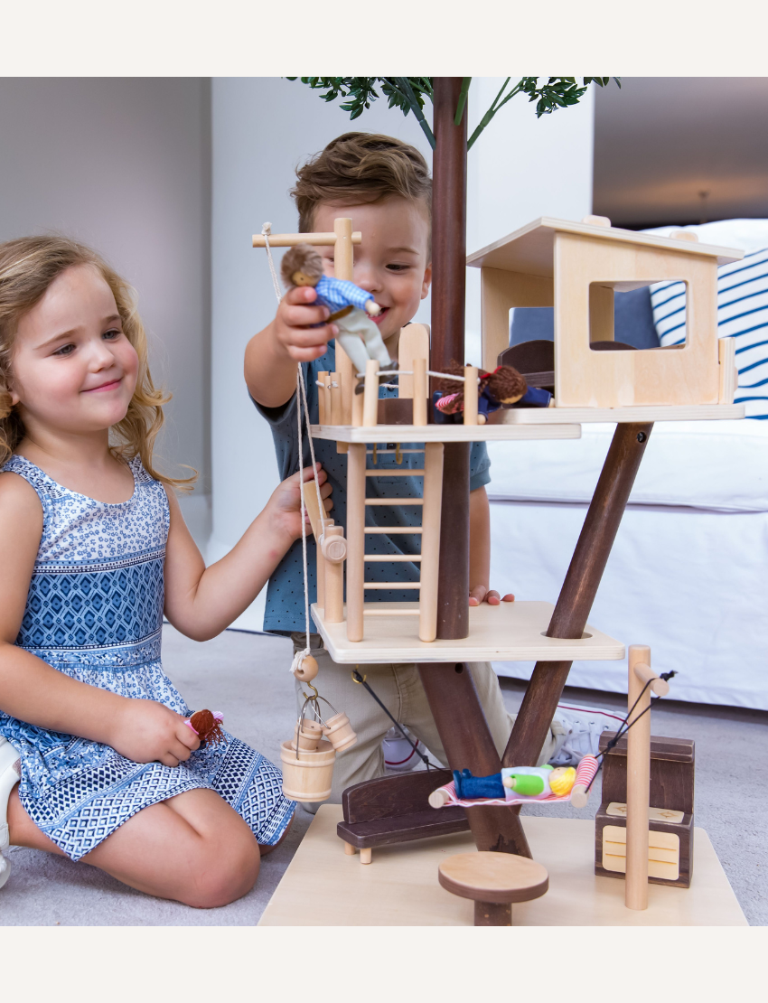 The EverEarth Tree House Dollhouse inspires imaginative adventures with its wooden multi-level design, where miniature dolls swing, slide, and relax among green leaves, fueling endless creativity in their whimsical world.