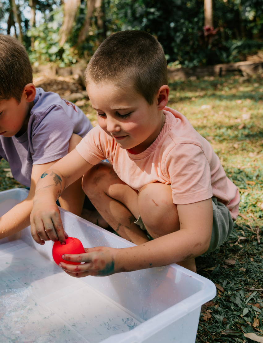 A white rectangular box with colorful circles features the text "Reusable Water Balloons" prominently. The eco-friendly package by Sensory Play Australia is set against a simple, light background.