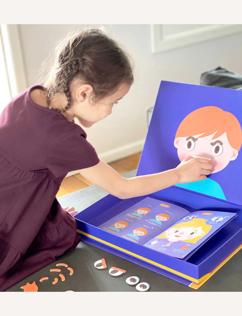 The educational board game box, "All About My Body + Emotion" by mierEdu, comes in a purple and orange design. It features illustrations of human anatomy and emotions, includes over 120 pieces, and is designed to teach children aged 4 and up about the human body and emotions.