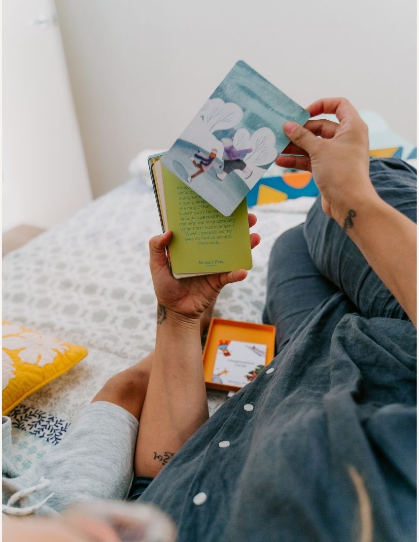 Two white boxes labeled "Imagination Cards Set in Box" by Sensory Play Australia are shown. The larger box is on the right, and the smaller box is on the left. The boxes feature illustrations of children engaging in imaginative activities, perfect for enhancing storytelling skills with a colorful background.