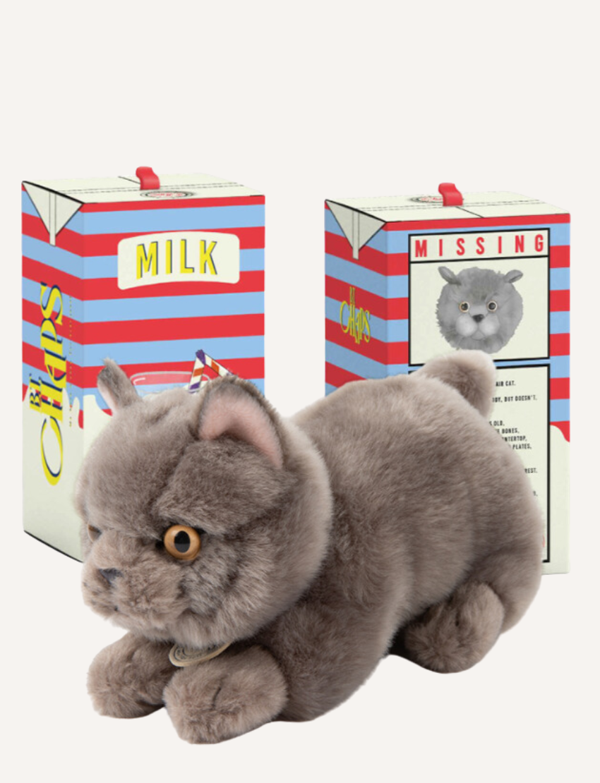 Two plush toys, part of the BT Chaps "Pets in Giftbox 15cm" collection, are set against a plain backdrop: an American Bulldog with floppy ears and a tag above a gray British Shorthair cat with a curled tail, yellow eyes, and its own tag.