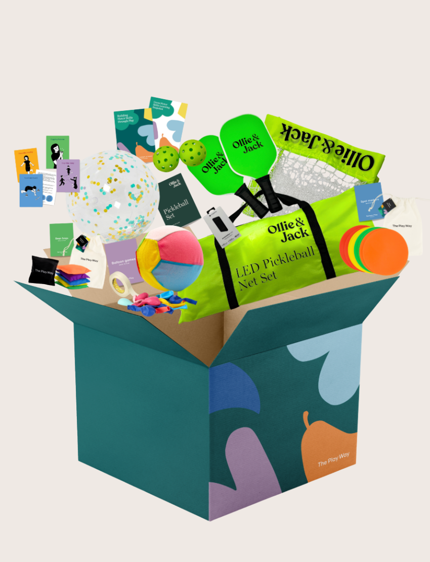 The Building Motor Skills through Play Program by Therapy At Home comes in a teal box with colorful shapes and includes an LED pickleball net set, paddle, balls, paint swatches, balloons, cards, frisbee, and more for fun skill-building activities.