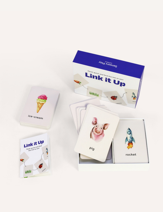 The image features the "Link it Up Game" by Sensory Play Australia, in a boxed set with a purple border. The front showcases cards linking a carrot, grass, ladybird, and rocket, and reads "Think quick and find the link to win!" Ideal for family fun and boosting word association skills!.