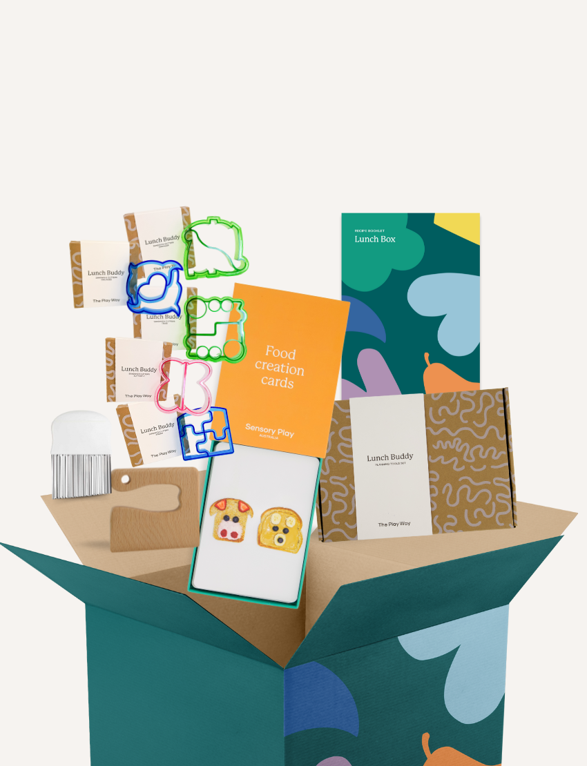 The Play Way's 'Lunch Box Creations' Kit: Lunch Buddy cutters and tools spilling from an open box. Inspires fun, creative meal prep.