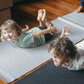 The Yoga & Mindfulness Program by Therapy At Home features an open teal box with abstract designs, holding a yoga mat, teal cushion, books, cards, and small items—perfect for home yoga and mindfulness—displayed upright against a simple background.