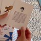 The Yoga & Mindfulness Program by Therapy At Home features an open teal box with abstract designs, holding a yoga mat, teal cushion, books, cards, and small items—perfect for home yoga and mindfulness—displayed upright against a simple background.
