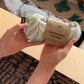 The Yoga & Mindfulness Program by Therapy At Home features an open teal box with abstract designs, holding a yoga mat, teal cushion, books, cards, and small items—perfect for home yoga and mindfulness—displayed upright against a simple background.
