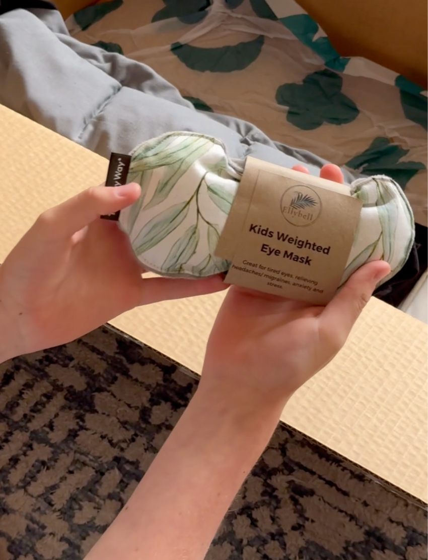 The Yoga & Mindfulness Program by Therapy At Home features an open teal box with abstract designs, holding a yoga mat, teal cushion, books, cards, and small items—perfect for home yoga and mindfulness—displayed upright against a simple background.