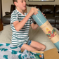 The Yoga & Mindfulness Program by Therapy At Home features an open teal box with abstract designs, holding a yoga mat, teal cushion, books, cards, and small items—perfect for home yoga and mindfulness—displayed upright against a simple background.