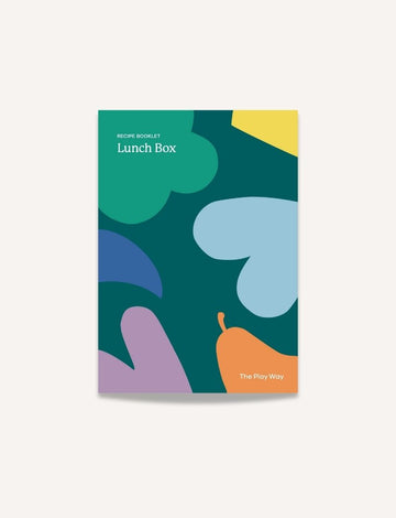 A recipe booklet called "Lunch Box Recipe Booklet" features an eye-catching abstract cover design, with shapes in green, blue, yellow, purple, and orange spread across a dark green background. The brand name "The Play Way" is prominently displayed at the bottom right corner.