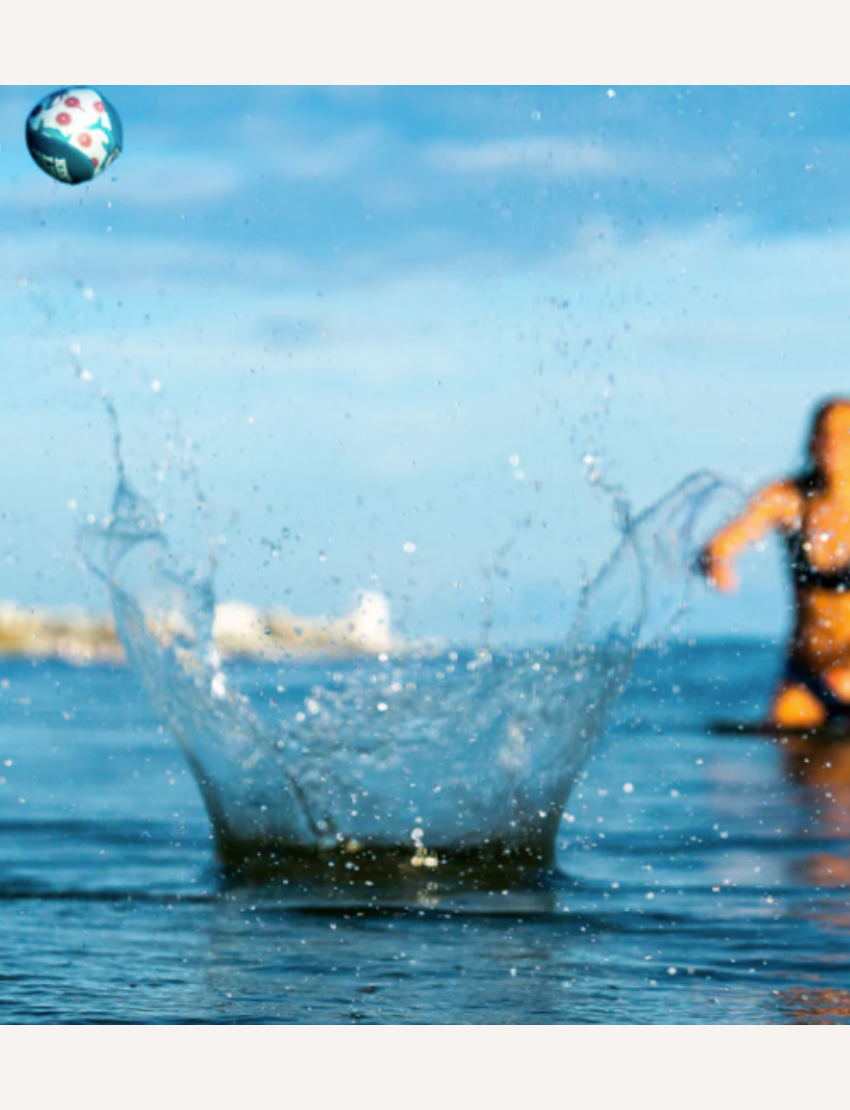 The Mini Twin Pack Water Bounce Balls packaging by Waboba features two colorful spheres, one in yellow and the other in teal, along with the catchy tagline "Bounces on Water!" The design is set against a beach scene with waves, and this pack promises "Double the fun" for playtime at oceans and lakes.